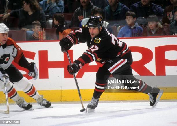 Paul Coffey of the Chicago Blackhawks passes the puck during an NHL game against the Philadelphia Flyers on December 19, 1998 at the First Union...