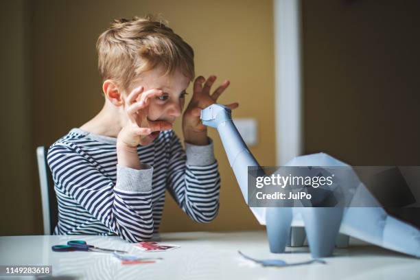 kid playing with toy dinosaur - dinosaur toy i stock pictures, royalty-free photos & images