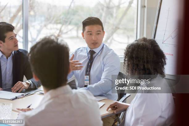 male hospital administrator meets with colleagues - medical sales representative stock pictures, royalty-free photos & images