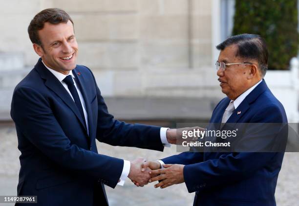 French President Emmanuel Macron welcomes Indonesia's Vice President Jusuf Kalla prior to their meeting at the Elysee Palace on May 15, 2019 in...