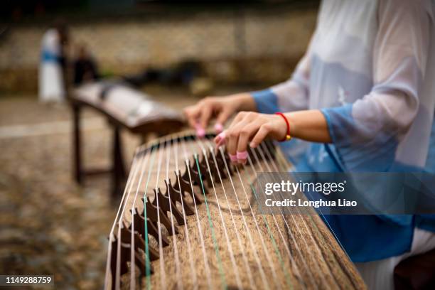 a young woman plays the zither - zither stock pictures, royalty-free photos & images