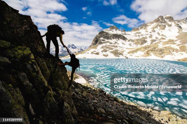 climbers at lej da la tscheppa, switzerland - graubunden canton stock pictures, royalty-free photos & images