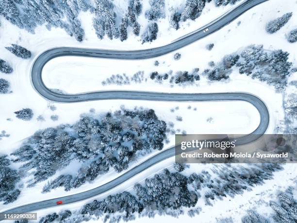 s-shape road from above, maloja pass, switzerland - snowy road stock-fotos und bilder