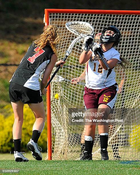 Madison's Katie Kerrigan scores past Oakton goalie Emily George during their championship game at Robinson Secondary High School in Fairfax, Va. On...