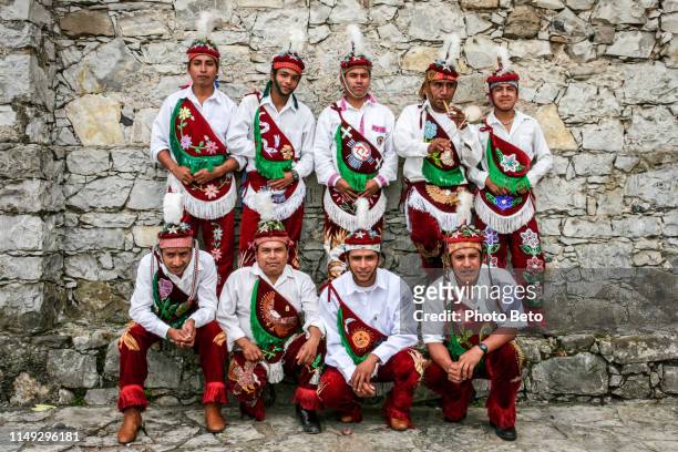a team of papantla flying men in traditional dress in cuetzalan eastern mexico - papantla stock pictures, royalty-free photos & images