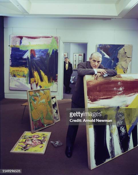 Portrait of Dutch artist Willem De Kooning , with several of his paintings, and American gallerist Sidney Janis in the latter's gallery, New York,...