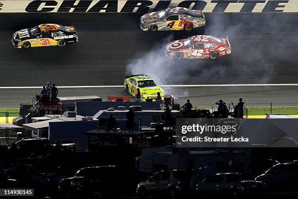 Paul Menard, driver of the Moen/Menards Chevrolet, spins out as Jeff Burton, driver of the Caterpillar Chevrolet, Kasey Kahne, driver of the Red Bull...