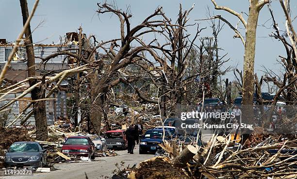 President Barack Obama visits an area destroyed a week ago by the massive tornado that hit Joplin, Missouri, Sunday, May 29, 2011. The President...