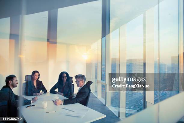 business colleagues planning together in meeting - four people office stock pictures, royalty-free photos & images