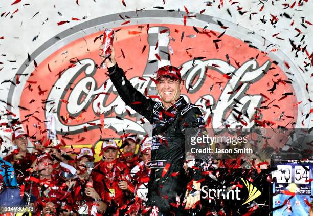 Kevin Harvick, driver of the Budweiser Armed Forces Tribute Chevrolet, celebrates in Victory Lane after winning the NASCAR Sprint Cup Series...