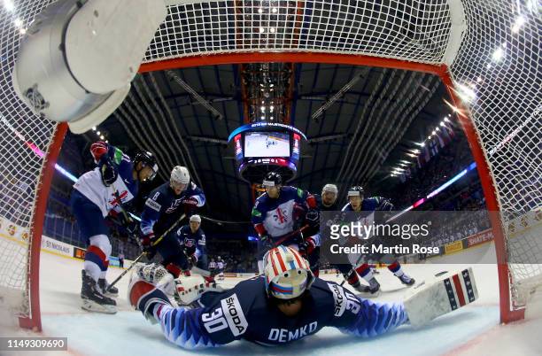Thatcher Demko, goaltender of United States tends net against Matthew Myers and Ben Lake of Great Britain during the 2019 IIHF Ice Hockey World...