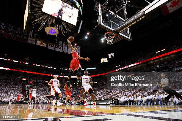 Derrick Rose of the Chicago Bulls dunks against LeBron James and Mike Bibby of the Miami Heat in Game Four of the Eastern Conference Finals during...