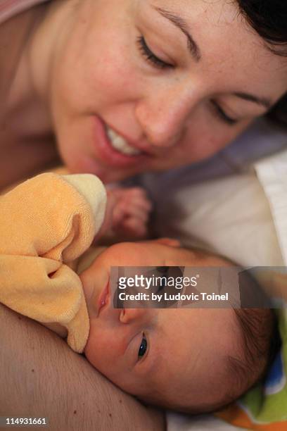 small baby with her mother - ludovic toinel stock-fotos und bilder
