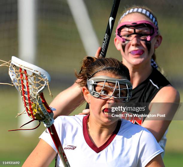 Oakton's Madison Ray heads up field away from Madison player Katie Kerrigan during their championship game at Robinson Secondary High School in...