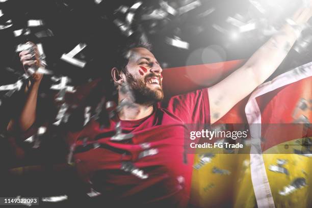 german fan celebrating with the national flag - germany football stock pictures, royalty-free photos & images