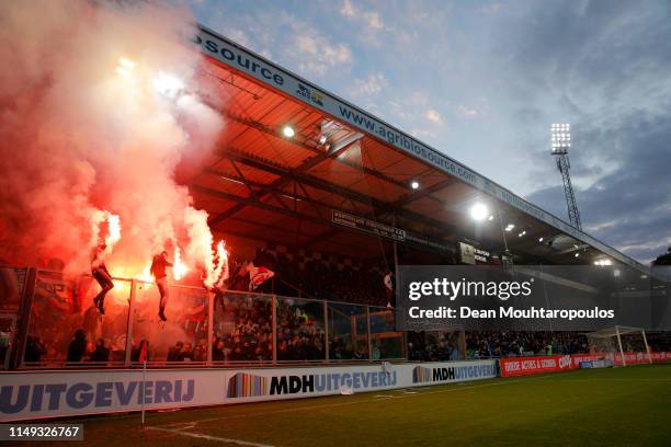 Fans of Ajax light flares during the Eredivisie match between De Graafschap and Ajax at Stadion De Vijverberg on May 15, 2019 in Doetinchem,...