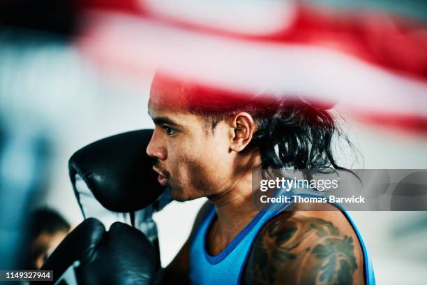 male boxer working out in ring in boxing gym - boxing man stock pictures, royalty-free photos & images