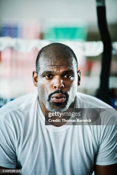 portrait of sweating male boxer breathing heavily after workout in boxing gym - chill by will 2018 imagens e fotografias de stock