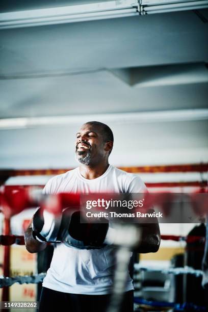 male boxer laughing during training session in boxing gym - funny hobbies stock pictures, royalty-free photos & images