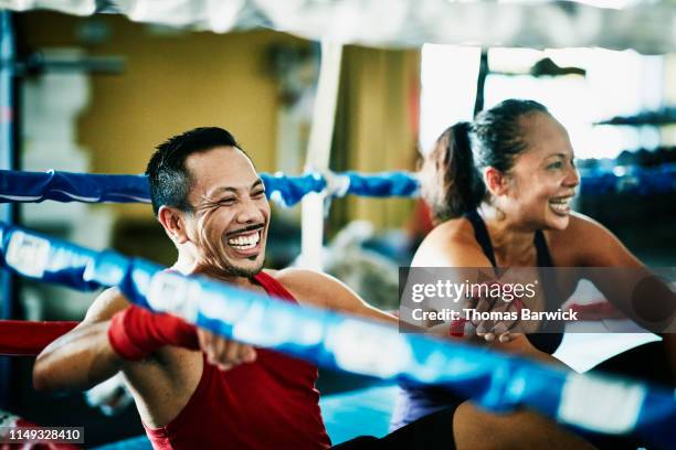 laughing boxers relaxing in ring after training session in boxing gym - indian freedom fighters stockfoto's en -beelden