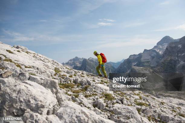 mountain climber walking in mountains - slovenia mountains stock pictures, royalty-free photos & images