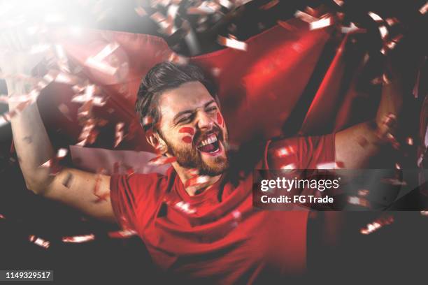 swiss fan celebrating with the national flag - fan enthusiast stock pictures, royalty-free photos & images