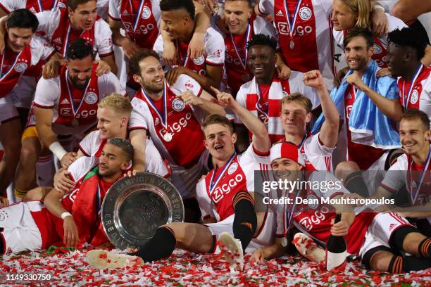 Players of Ajax celebrate with the trophy after winning the Eredivisie following the Eredivisie match between De Graafschap and Ajax at Stadion De...