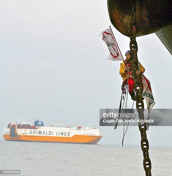 Greenpeace activist remains attached to the anchor chain of cargo ship Global Wind 03 May, 2004 anchored offshore 40 kms from the port of Paranagua,...