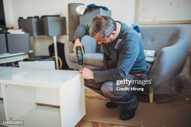senior man using cordless screwdriver - cordless device stock pictures, royalty-free photos & images
