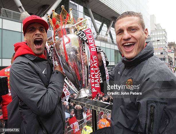 Rio Ferdinand and Nemanja Vidic of Manchester United pose with the Barclays Premier League trophy during the Manchester United Premier League Winners...