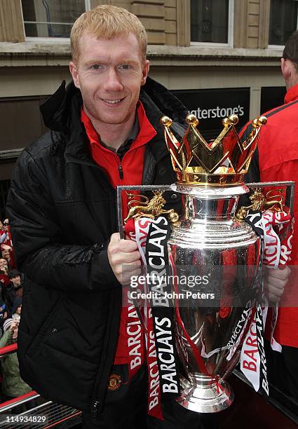 Paul Scholes of Manchester United poses with the Barclays Premier League trophy during the Manchester United Premier League Winners Parade on May 30,...