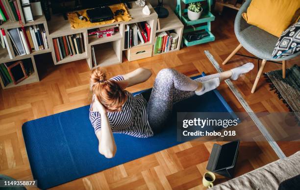 woman exercising at home - lazy exercise stock pictures, royalty-free photos & images