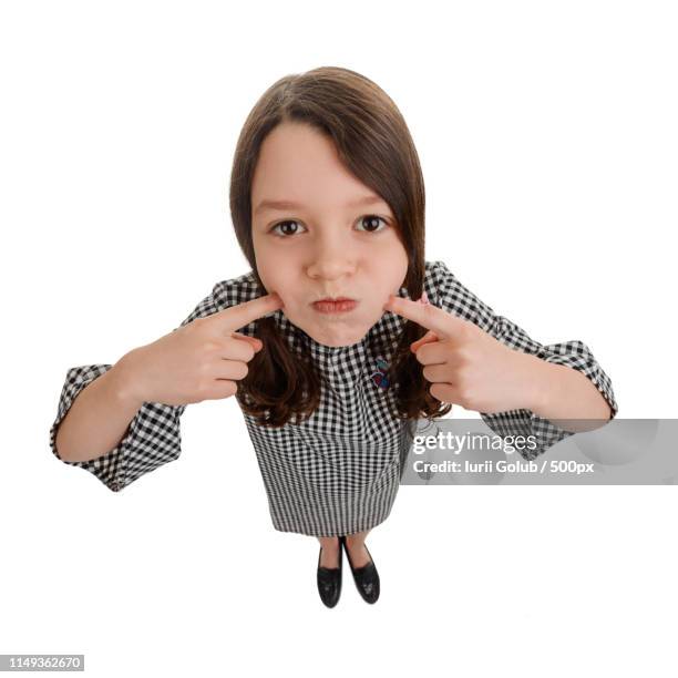 carefree girl blowing her cheeks - cheek stock pictures, royalty-free photos & images