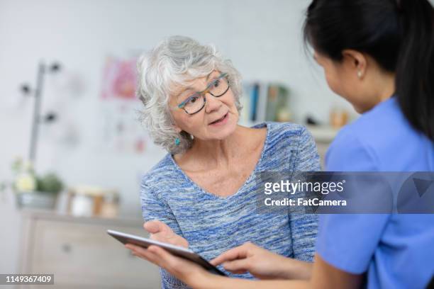 senior woman at the doctors - diabetes and heart disease stock pictures, royalty-free photos & images