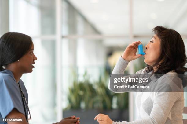 korean asthmatic woman meets with doctor - old cough stock pictures, royalty-free photos & images