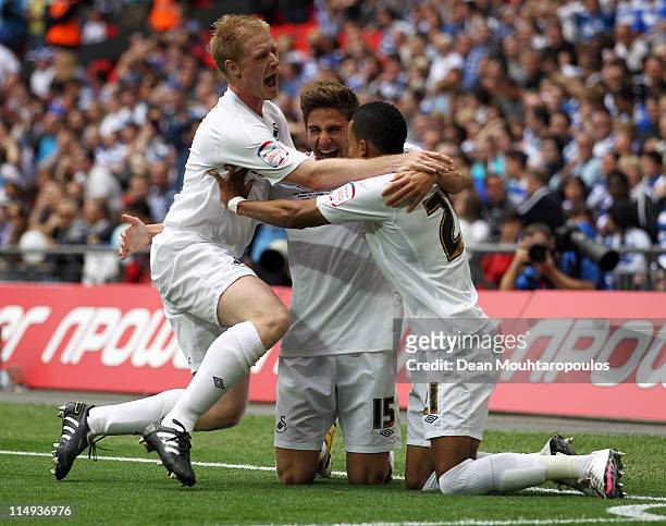 Scott Sinclair of Swansea celebrates with Fabio Borini and Alan Tate after he scores a penalty during the npower Championship Playoff Final between...