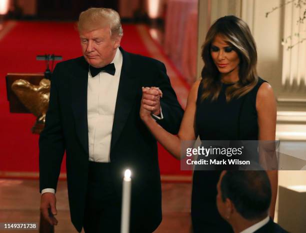 President Donald Trump and first lady Melania Trump attend the White House Historical Association Dinner in the East Room of the White House on May...