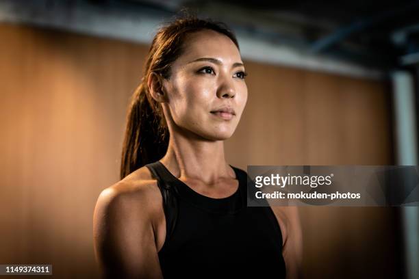 portrait of a japanese female standing in a gym - beautiful japanese women stock pictures, royalty-free photos & images