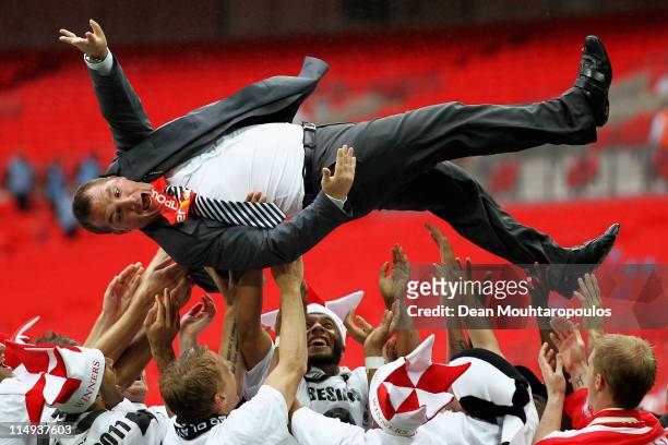 Swansea Manager, Brendan Rodgers is thrown in the air by his players after winning the npower Championship Playoff Final between Reading and Swansea...