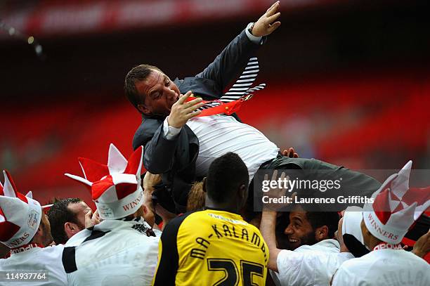 Brendan Rogers of Swansea City is thrown in the air by his players after victory in the npower Championship Playoff Final between Reading and Swansea...