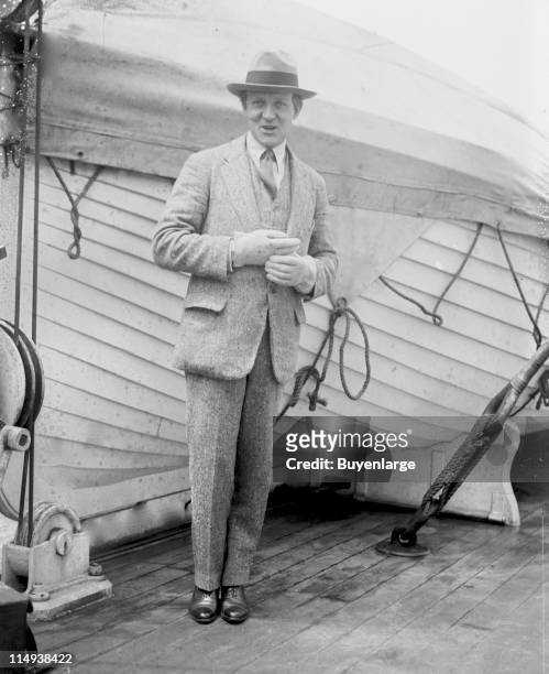 Portrait of conductor Leopold Stokowski , standing on board an unidentified ocean liner, early twentieth century.