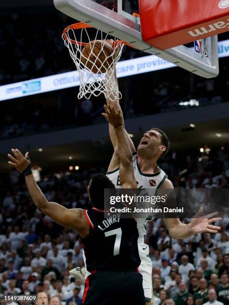 Brook Lopez of the Milwaukee Bucks dunks the ball over Kyle Lowry of the Toronto Raptors in the fourth quarter in Game One of the Eastern Conference...