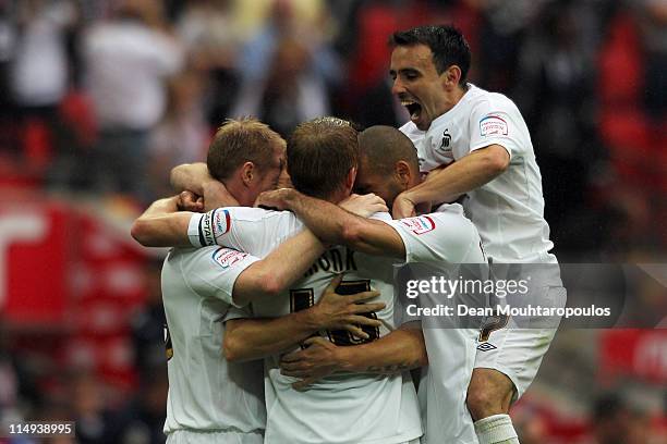 Leon Britton of Swansea celebrates with the team mates after winning the npower Championship Playoff Final between Reading and Swansea City at...