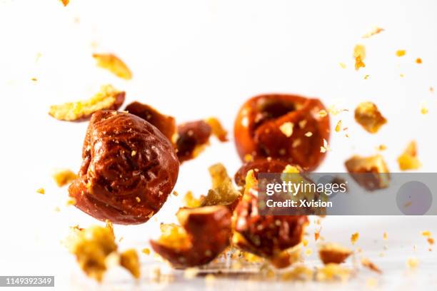 red date dehydrated food in mid air captured with high speed with white background"n - azufaifo fotografías e imágenes de stock