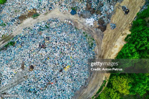aerial view of dump in forest. pollution concept, top view. - landfill foto e immagini stock