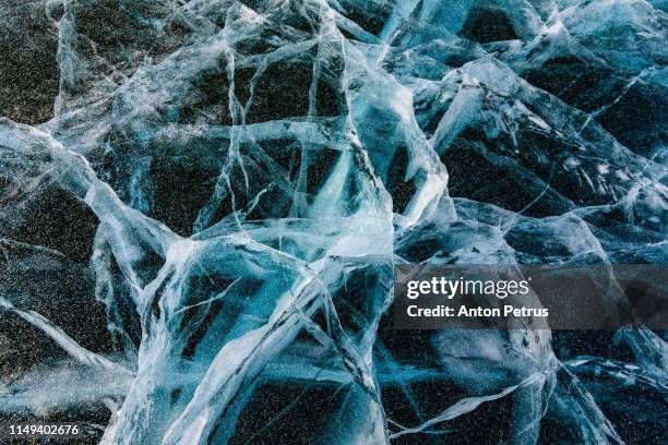 ice with cracks in lake baikal in winter - crystal caves stock pictures, royalty-free photos & images