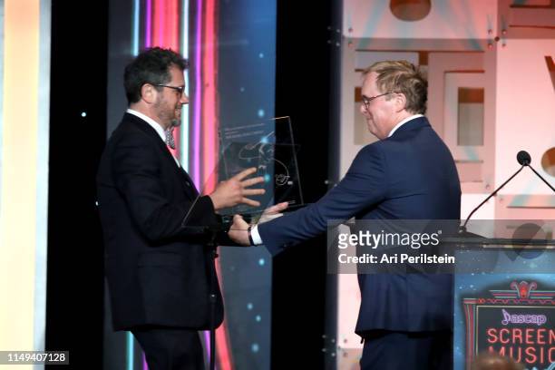 Director Brad Bird presents the Henry Mancini Award to Michael Giacchino onstage during the ASCAP 2019 Screen Music Awards Show at The Beverly Hilton...