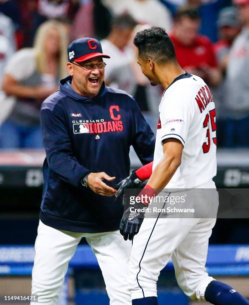 Manager Terry Francona of the Cleveland Indians congratulates Oscar Mercado after he hit a game winning single off Raisel Iglesias of the Cincinnati...