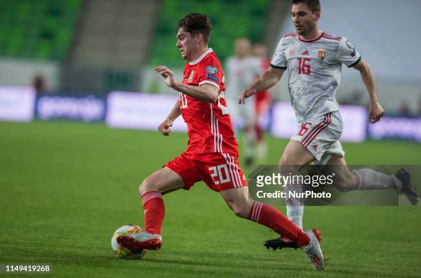 Daniel James of Wales competes for the ball with Mate Pátkai of Hungary during the Hungary and Wales European Qualifier match at Groupama stadium on...