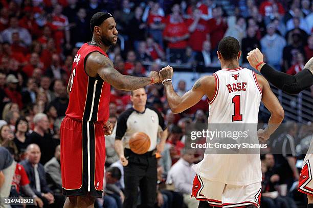 LeBron James of the Miami Heat greets Derrick Rose of the Chicago Bulls as they get set to play in Game Two of the Eastern Conference Finals during...